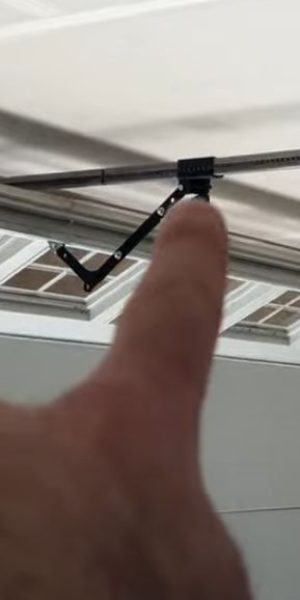 tech pointing at garage door repair auburn al